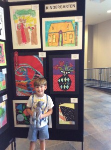 Hank Nagem poses by his painting at the BRACE art show