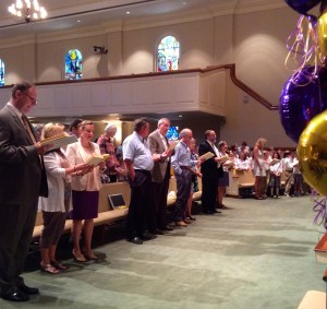 Members of the Westminster Academy founding families and faculty sing the school song during the 20th Anniversary Assembly